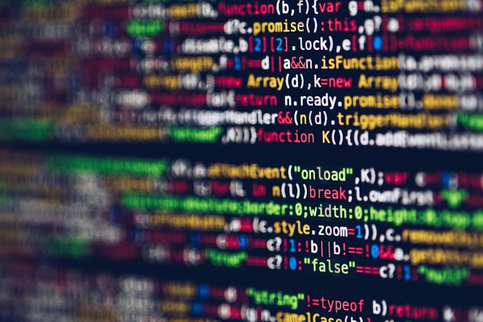 This image shows a computer screen displaying a coding editor with lines of programming code in various colors, including green, blue, purple, and white, on a dark background. To the left, part of a d